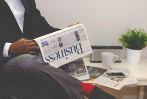 person reading the business newspaper